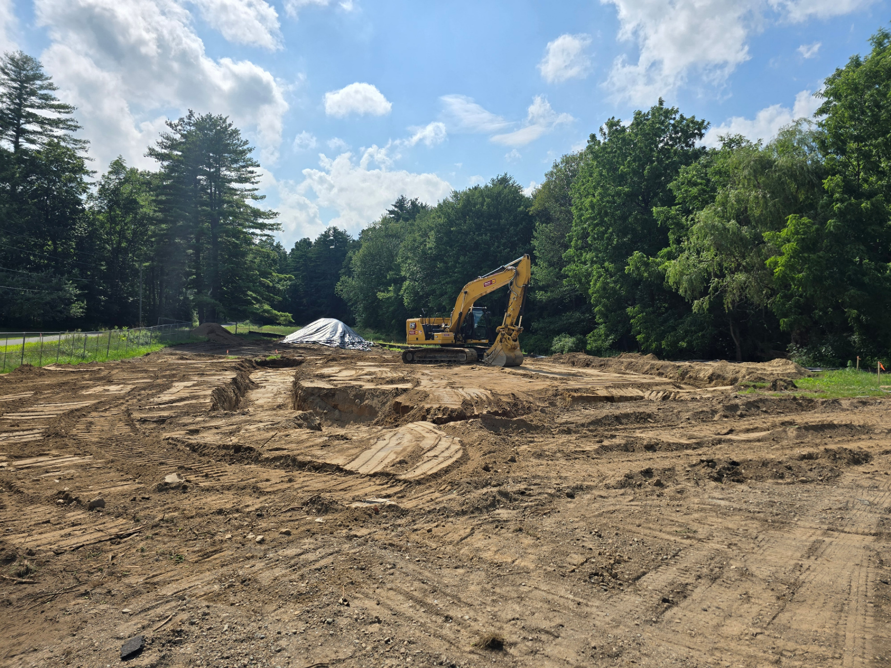 Excavator preparing a residential building pad in Western Massachusetts
